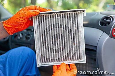 Replacement of dirty cabin pollen air filter for a car. Basic auto mechanic skills concept. Stock Photo