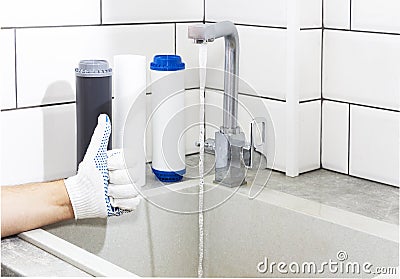 Replacement of filters in the water purification system. Close-up view of three new filters. Clean water at home. Thumbs up Stock Photo