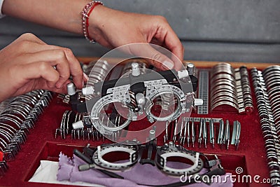 Replacement parts in below. Female hands holding the optical device for eye testing Stock Photo