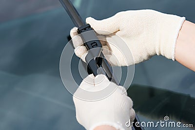 Replacement of windscreen wipers, specialist in rag gloves Stock Photo