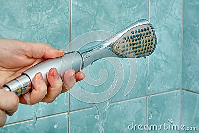 Replacing old cracked shower head in bathroom Stock Photo