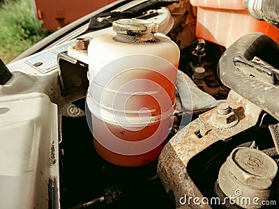 Replacing vehicle red power steering fluid Stock Photo