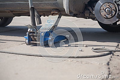 Jacked up car wheel replacement Stock Photo