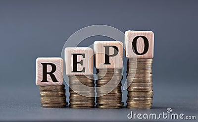 REPO - word on wooden cubes on coins on a gray background Stock Photo