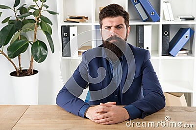 Report and complaint concept. Man bearded hipster boss looking at you with attention. Boss sit in office. Boss receive Stock Photo