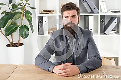 Report and complaint concept. Man bearded hipster boss looking at you with attention. Boss sit in office. Boss receive Stock Photo