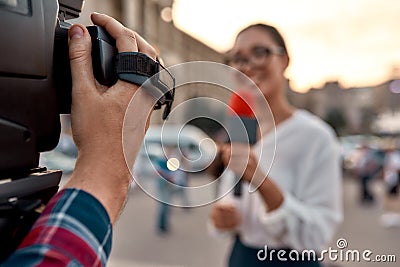 We report to you. TV reporter presenting the news outdoors. Journalism industry, live streaming concept. Stock Photo