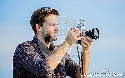 Reporter taking photo. Vintage equipment. Blogger shooting vlog. Vacation time. Handsome blogger guy traveler retro Stock Photo