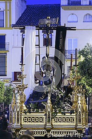 Holy Week in Seville, allegorical of the santa cruz triumph over death, the canine Editorial Stock Photo