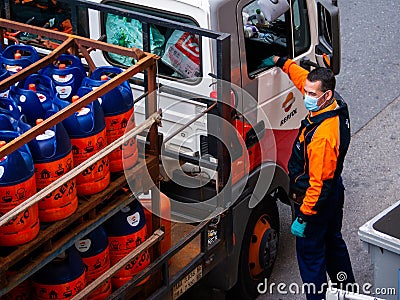Repsol gas tank truck, worker wearing face mask Editorial Stock Photo