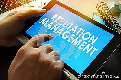 Reputation management on a screen of tablet. Stock Photo