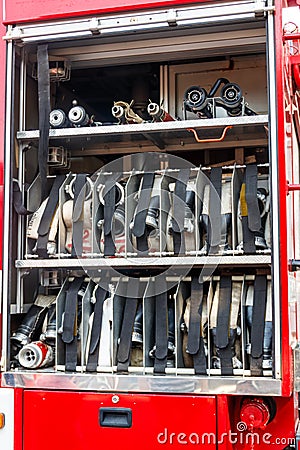 Rescue fire truck equipment. Compartment of rolled up fire hoses on a fire engine Stock Photo