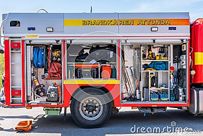 Rescue firetruck vehicle with open hatches displaying different equipment. Editorial Stock Photo