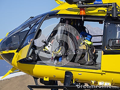 Rescue helicopter over the mountains to help hikers. First aid helicopter. Close-up to the cabin. Doors open Editorial Stock Photo