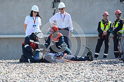 A rescue team in training sessions provides first aid to an electrician mannequin who has been injured by electric shock. Editorial Stock Photo