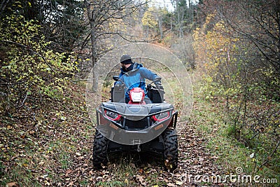 Rescuer Inspecting Woods Area by Atv Quad Bike Stock Photo