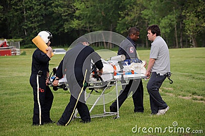 Rescuers rush an injured to Medivac helicopter Editorial Stock Photo