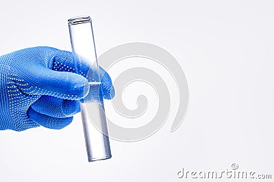 Research on the content of hazardous components and chemical elements. Hand in glove holding tube with drinking water on gray back Stock Photo