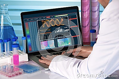 Research geneticist using computer biotechnology lab Stock Photo