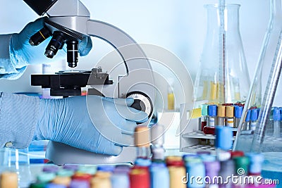 Researcher at the microscope lab workbench Stock Photo