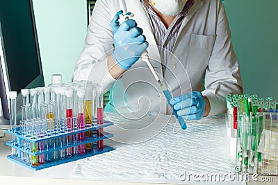 Researcher pipetting sample for study in tube Stock Photo