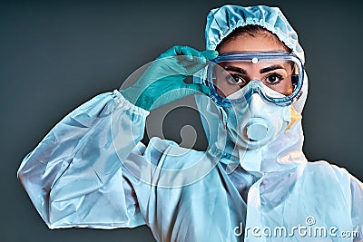 Researcher wearing hazmat protective suit and safety goggles Stock Photo