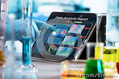 Researcher working with data analysis report in digital tablet o Stock Photo