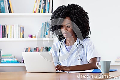 Researching african american medical female student at computer Stock Photo