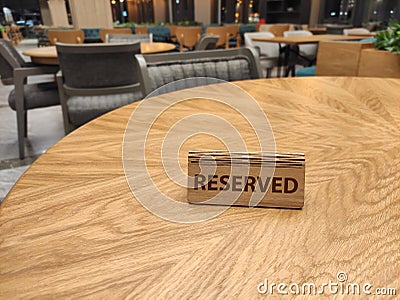 Wooden reserved sign in restaurant on table Stock Photo