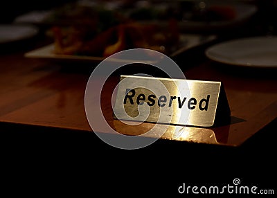 Reserved table sign in restaurant, silver reserved plate Stock Photo