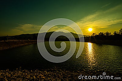 Reservoir with mountain view at sunset Stock Photo