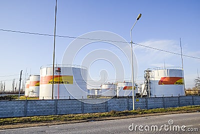 Reservoirs with fuel at the oil depot of Rosneft. Tanks in the light of the setting sun. Editorial Stock Photo