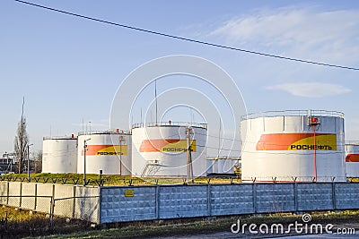 Reservoirs with fuel at the oil depot of Rosneft. Tanks in the light of the setting sun. Editorial Stock Photo