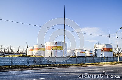 Reservoirs with fuel at the oil depot of Rosneft. Tanks in the light of the setting sun. Editorial Stock Photo
