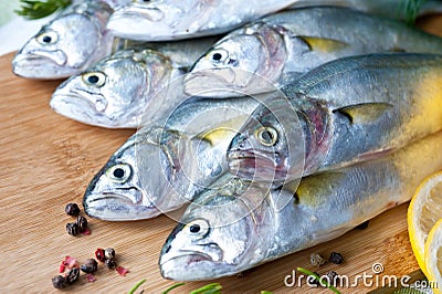 Resh fish with the vegetables, condiment and lemon, bluefish. Food preparation. Stock Photo