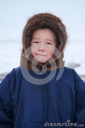 A resident of the tundra, indigenous residents of the Far North, tundra, open area, children ride on sledges, children in Stock Photo