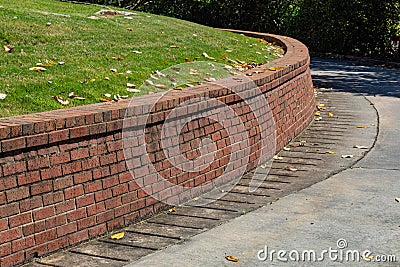 Residential brick retaining wall, curved along driveway Stock Photo