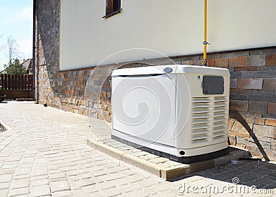 Residential house natural gas backup generator. Choosing a location for house standby generator. Stock Photo