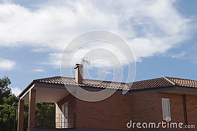 A residential house with an antenna on the roof Stock Photo
