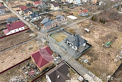 Residential houses with roof tops covered with metallic and ceramic shingles in rural suburban area Editorial Stock Photo