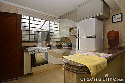 Residential kitchen with: sink, stove, refrigerator and other accessories. Brazil, South America Editorial Stock Photo