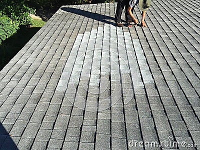 Residential Shingle Roof Leak Repairs; Roofer Editorial Stock Photo