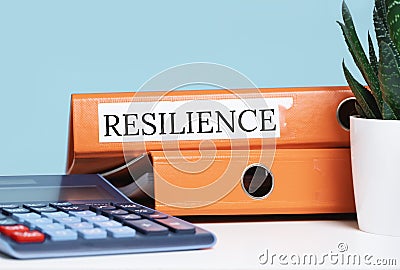 Resilience word on office desk folder. Calculator Stock Photo