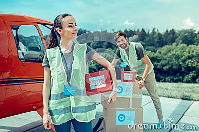 Resolute long-haired woman being proud of her work and activity Stock Photo