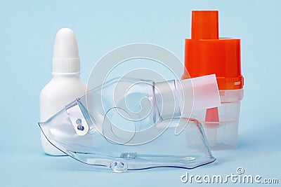 Respiratory mask and atomizing cup for compressor inhaler on blue Stock Photo