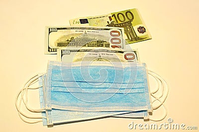 Respiratory masks, dollars and euro money in a white background Stock Photo