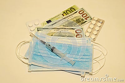 respiratory masks, syringe, pills, dollars and euros in a white background Stock Photo