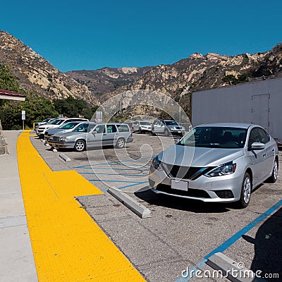 Rest area on California Highway in USA with a parking lot, cars, people and toilet Editorial Stock Photo