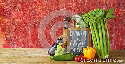 Restaurant announcing reopening on blackboard after the corona lockdown, gastronomy, food business shutdown.Food ingredients Stock Photo