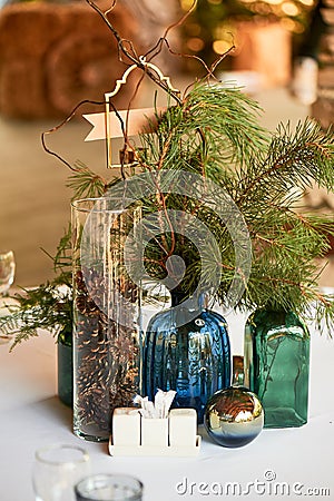 Restaurant design.A table covered with a white tablecloth, a classic serving. Bottles of blue and green glass. Paws ate. Stock Photo